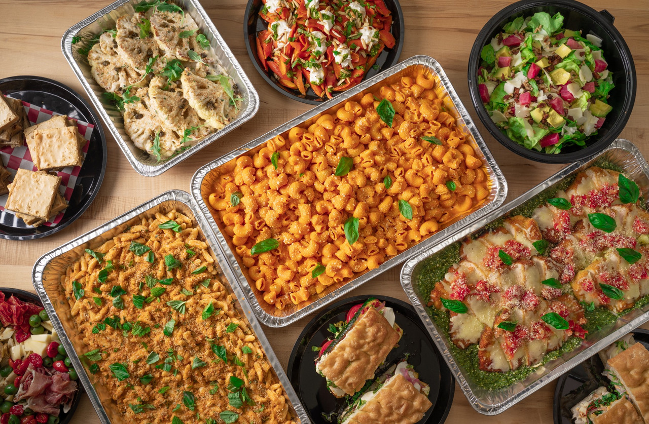 Prepared meals and family style catering photography with pasta trays, salads, sandwiches, and full meal spreads in Chicago