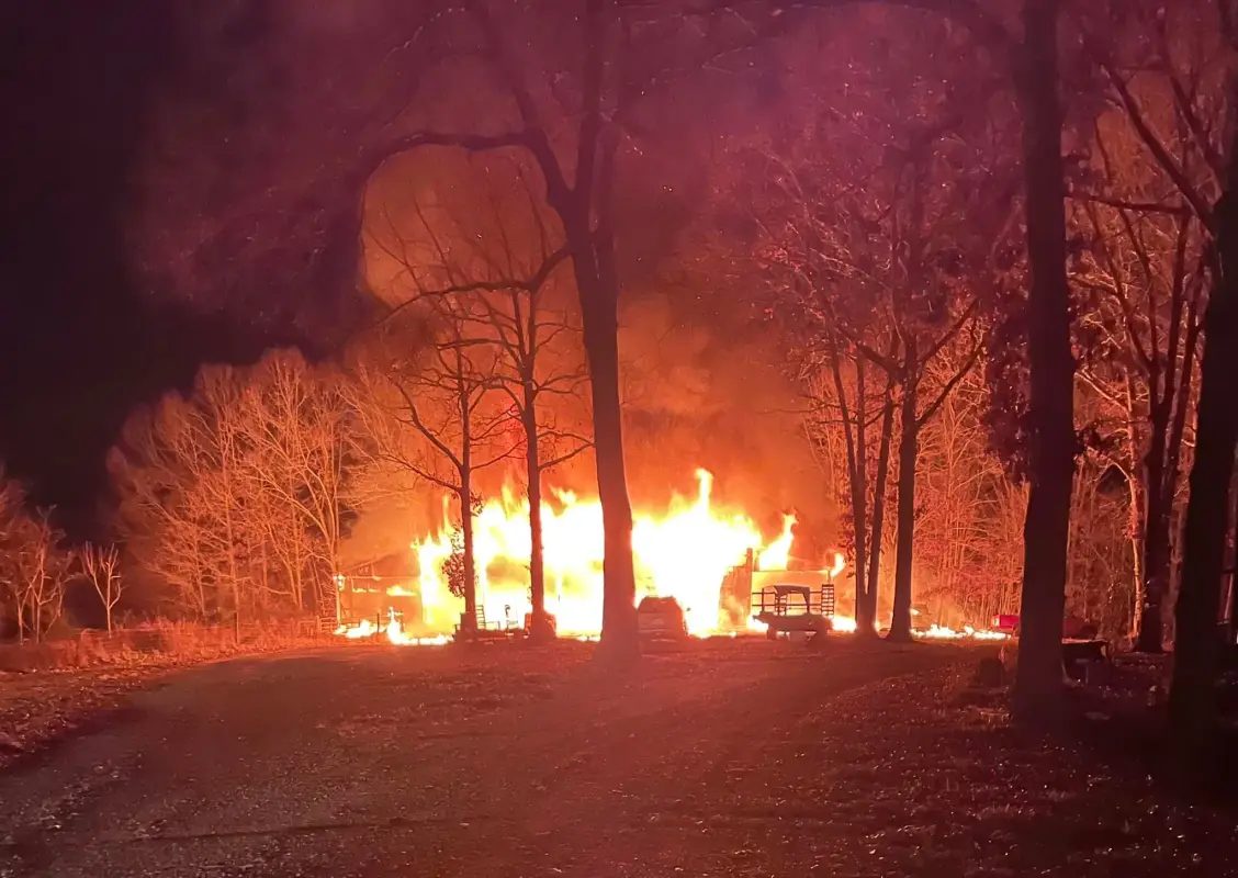 Burning Wreckage in forest at night.