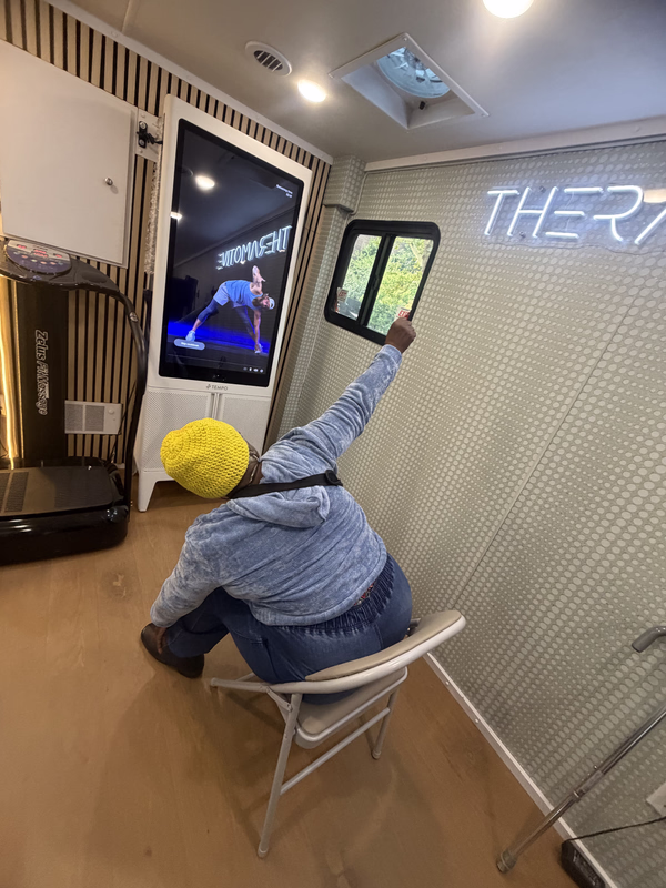 Patient receiving physical therapy inside a mobile clinic