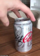 6168252-6388279-The_can_of_Diet_Coke_pictured_looks_like_a_normal_can_but_actual-a-33_1542200532481