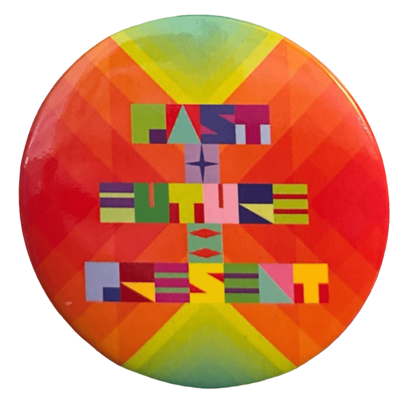 a pin of a piece of jeffrey gibson's art from his exhibit at the broad. it features bright colors, the background mostly red orange yellow and green, and a stylized font with the text 'PAST + PRESENT = FUTURE'