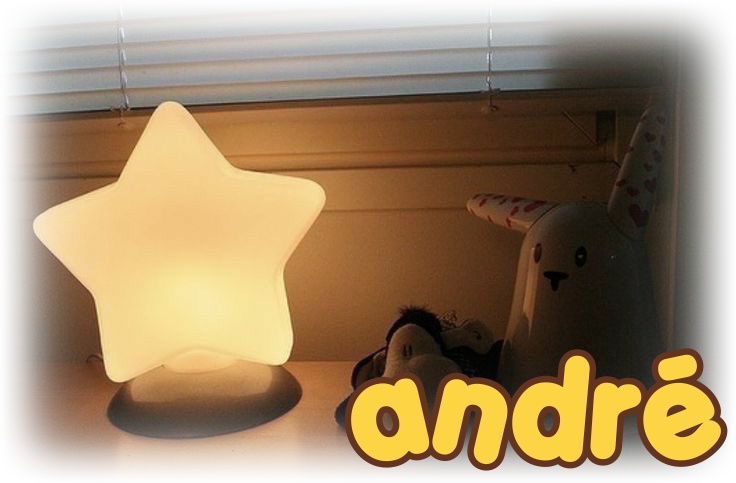 "andré" is written in the font porky's, and is on top of an image of a desk. the image is dark, the light of it coming from a star shaped lamp.