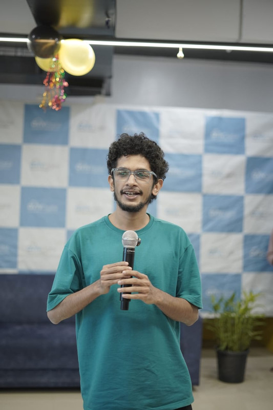 Muhammed Lisan A speaking into a microphone at an Aviv Digital event