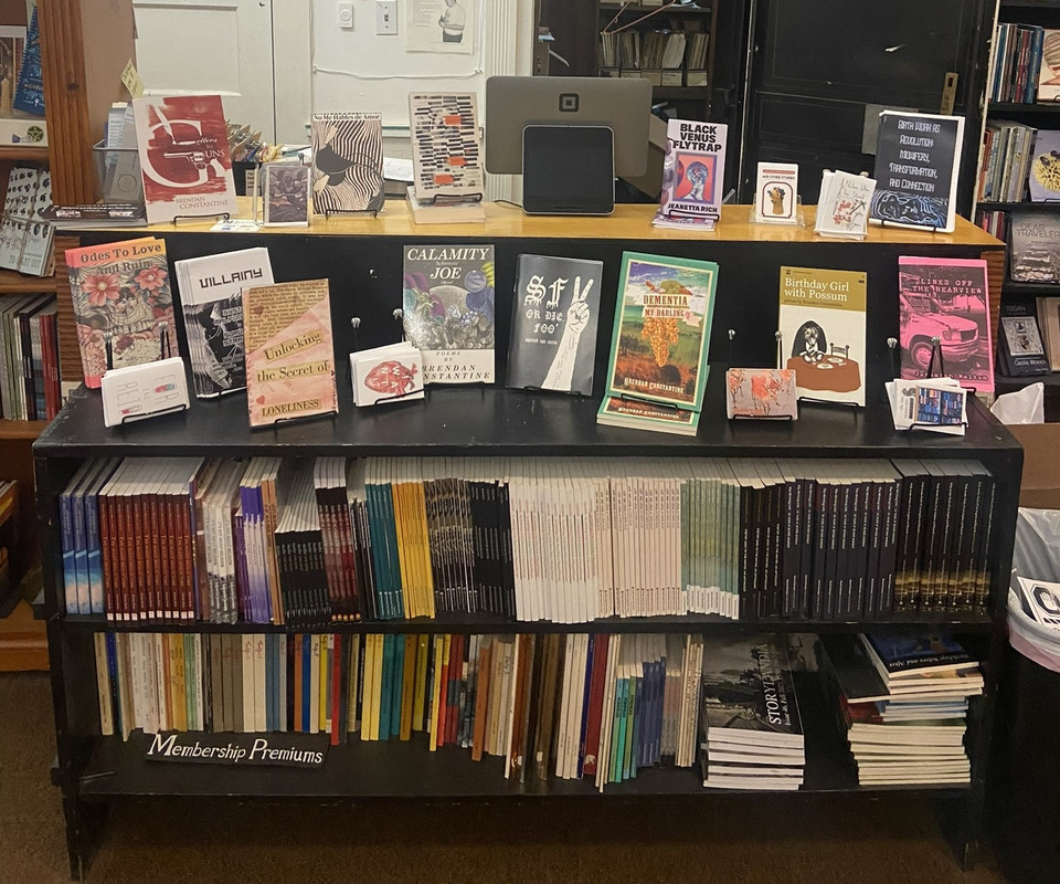 Photo of the front desk of Beyond Baroque, with many of my zines displayed for sale