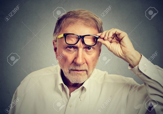 74961242-skeptical-senior-man-with-glasses-looking-at-you-isolated-on-gray-background-human-emotions.jpg
