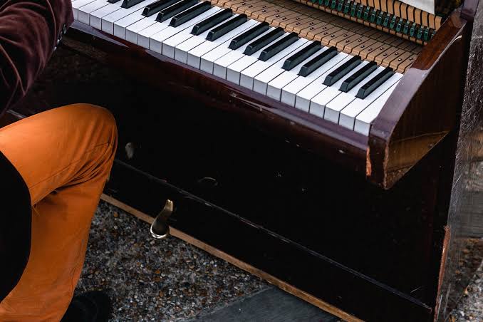 digital piano player practising with sustain pedal