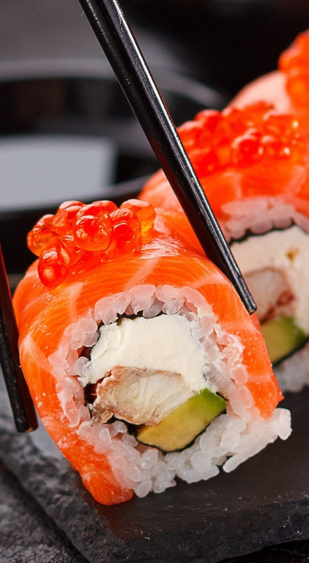 Black chopsticks and plates with vibrant sushi Pair with a DIY kit