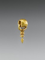Gold earring with thick upper ring and a thinner ring through it dangling decorations.