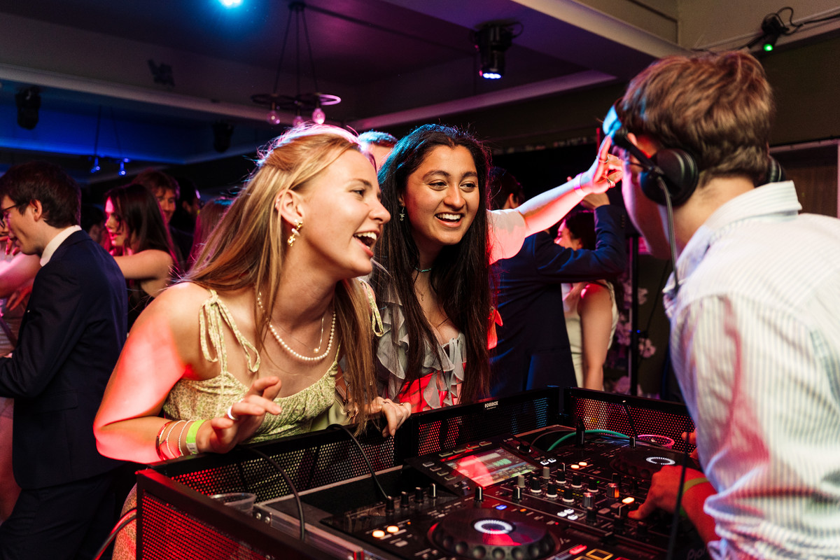 A DJ mixing music on the decks at a party