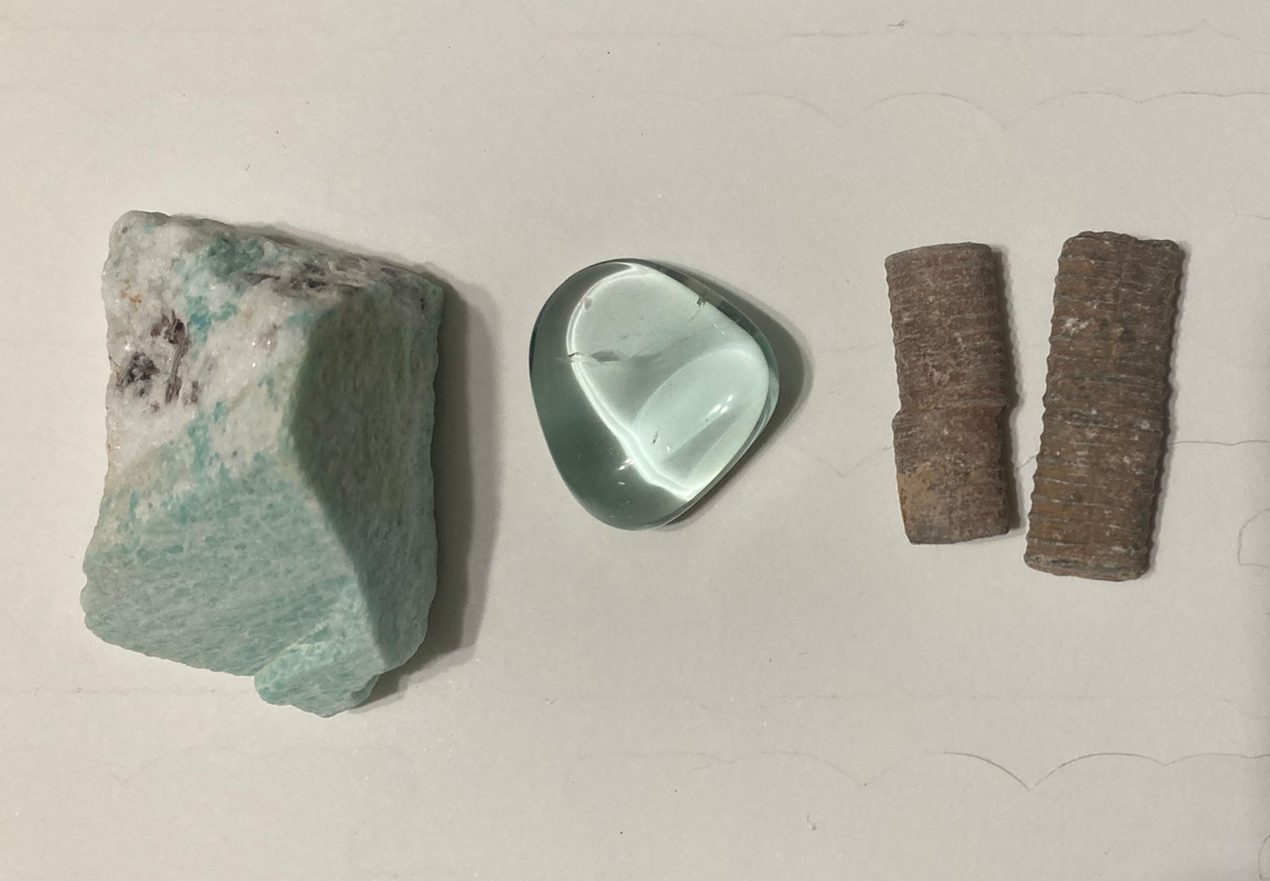 Raw Amazonite, tumbled aqua blue obsidian, raw crinoid fossils, information sheet