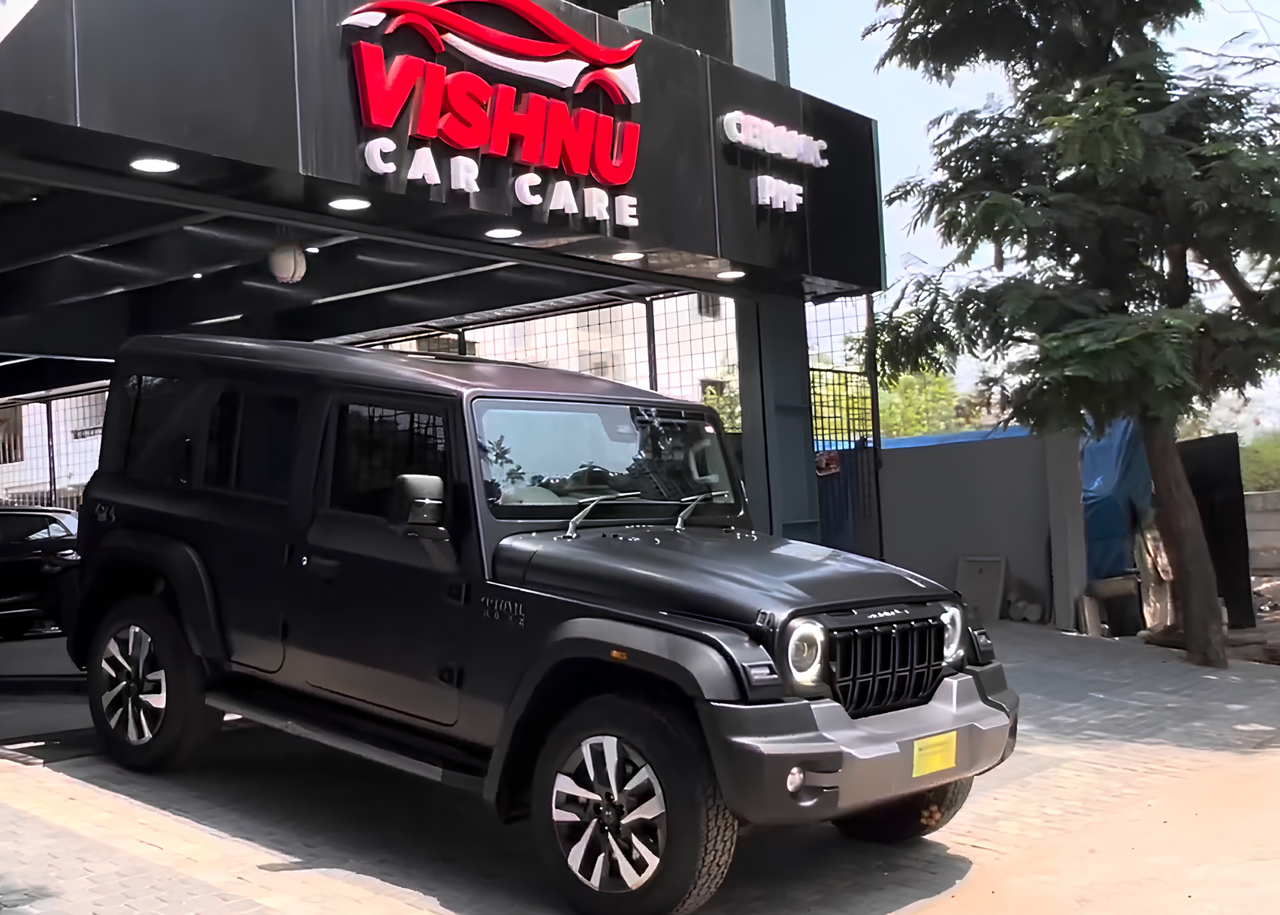 Vishnu Car Care installers fitting computer-cut Matte PPF on a car