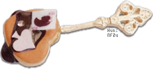 Golden spoon holding a heart pastry with a spade and card on top