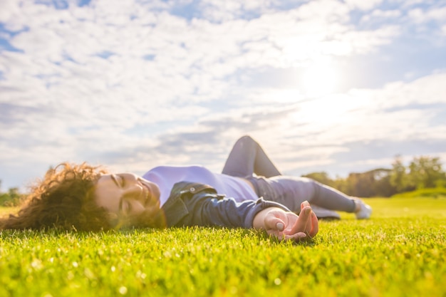 happy-woman-lay-grass-sky-background-474601-6962.jpg