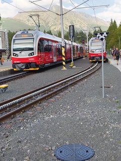 two red trains and rack railway track