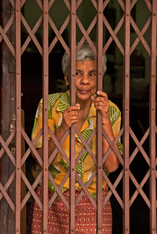 Lady behind gate