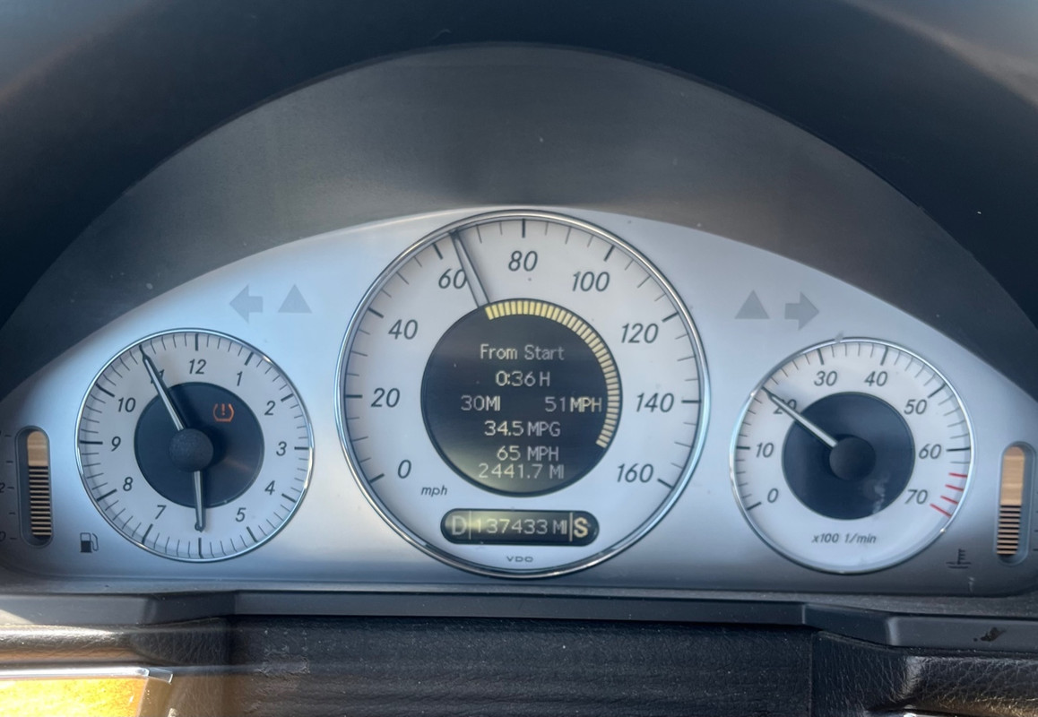 Mercedes E350 fuel economy display showing 34.5 MPG at 65 MPH