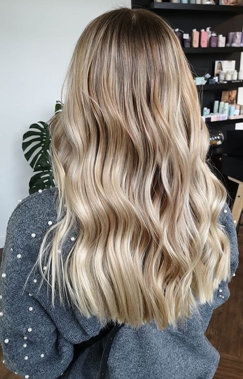 Balayage hairstyle on long wavy dark blonde hair