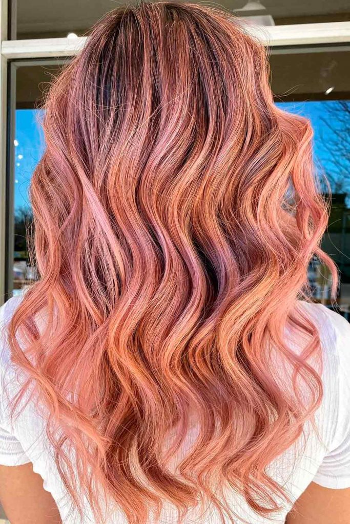 Long wavy strawberry highlighted blonde hair color