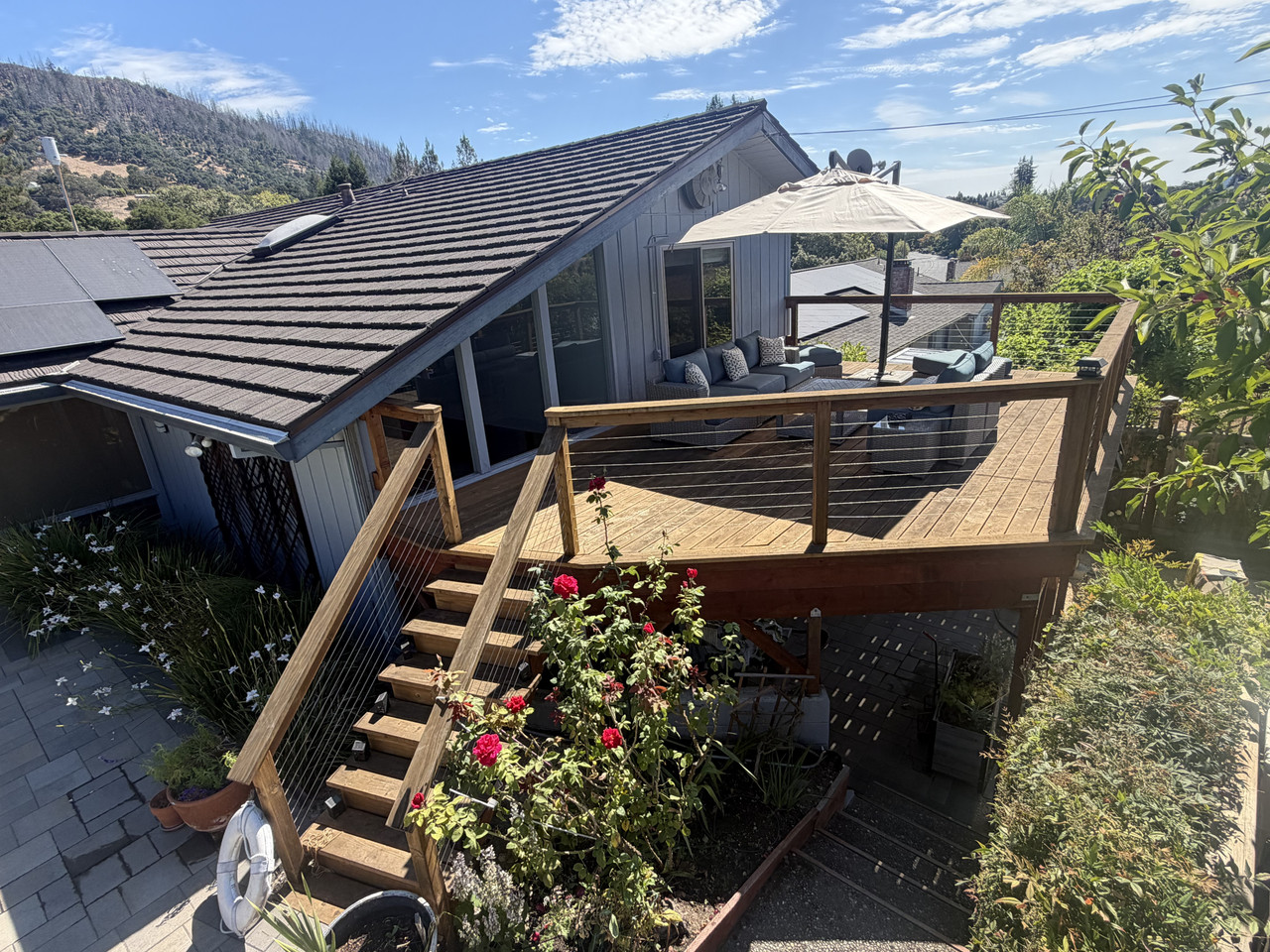 Finished redwood deck with cable railing after full rebuild
