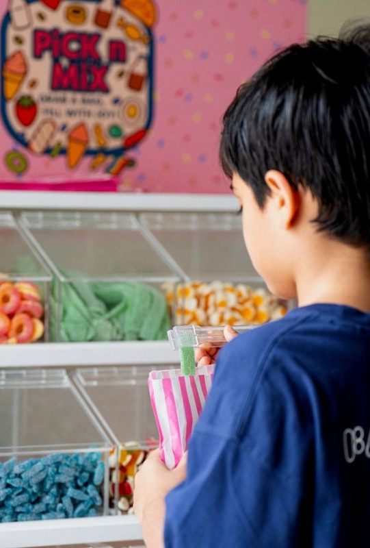 Child enjoying Sweet Spot candy stand at event