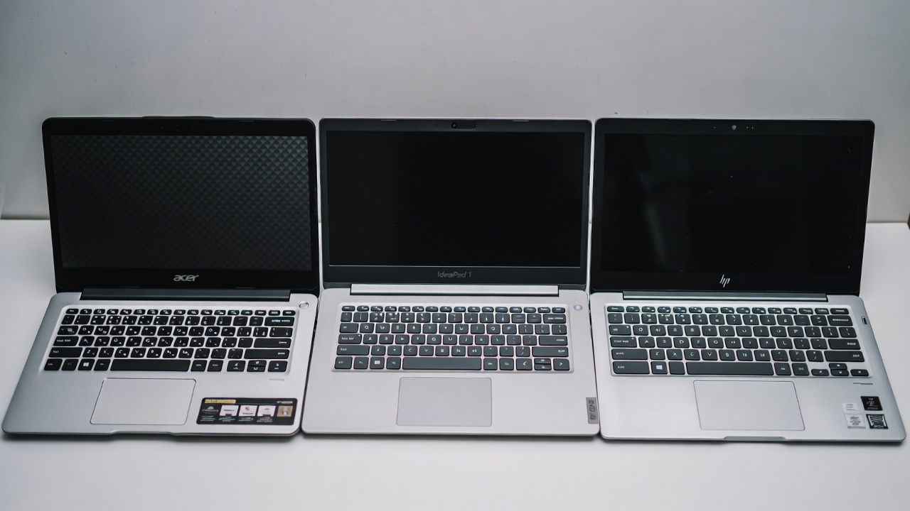 Three budget laptops side by side showing design differences: Acer Aspire 3, Lenovo IdeaPad 1, and HP Chromebook Plus