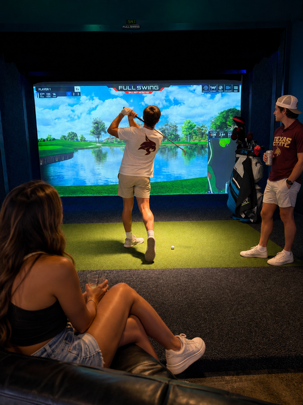 College friends enjoying the golf simulator