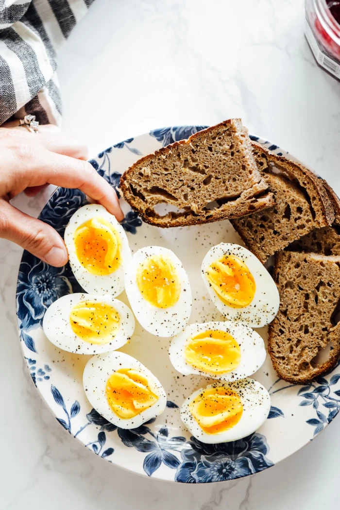 Seasoned boiled eggs cut in half and served with brown bread