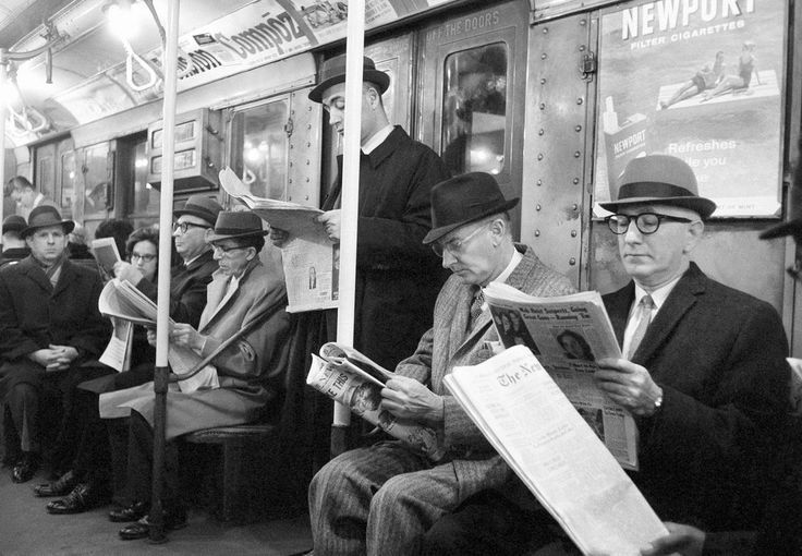 People read their morning newspapers on New York s subway en route to work 1963