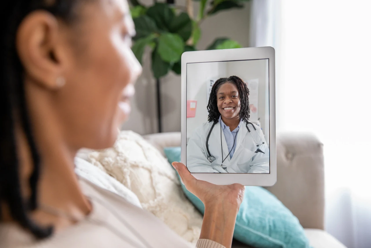 A patient in a relaxed home setting having a video consultation with a doctor