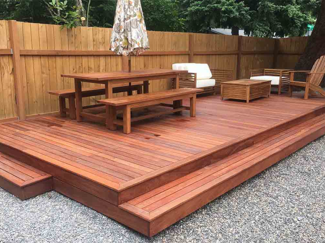 Covered deck with outdoor kitchen and dining area