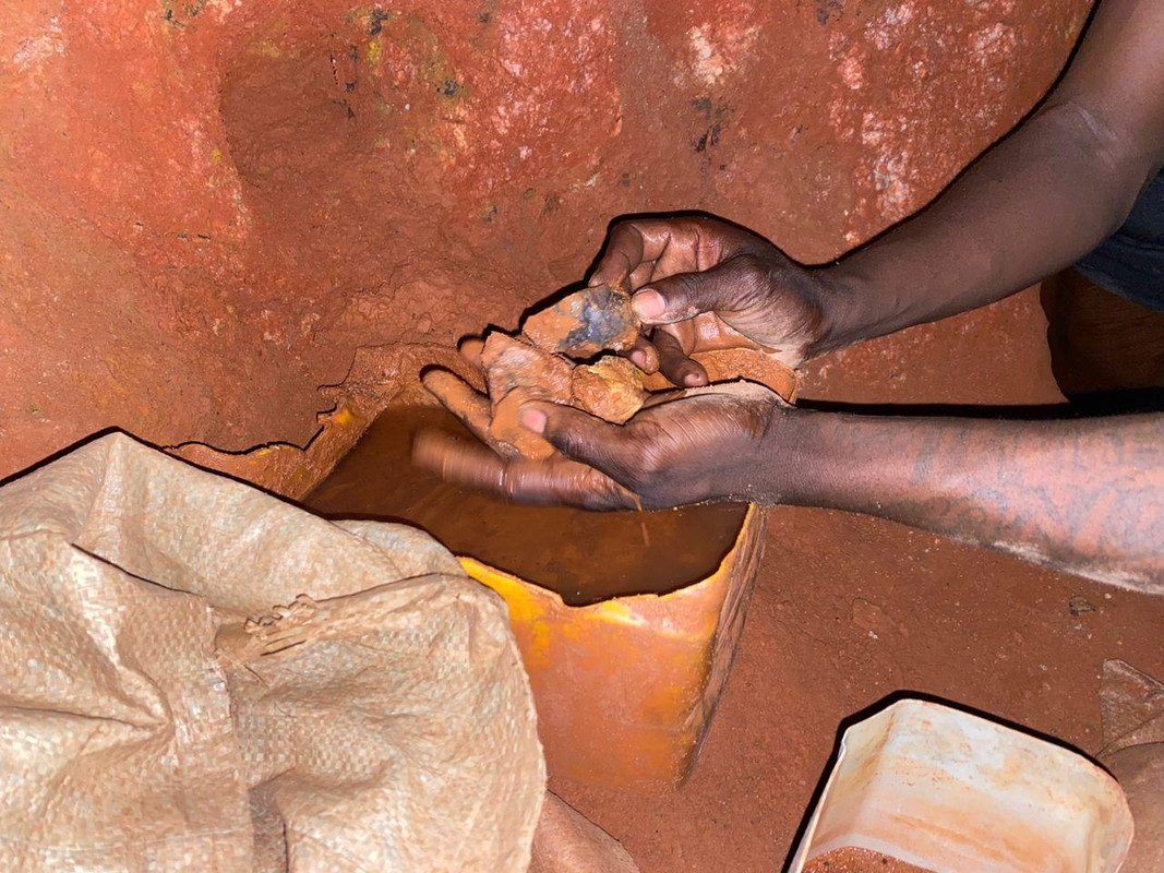 Miner holding gold ore - Ethical mining practices