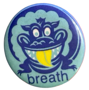 a light blue pin with a weird, dark blue monster on it-- sort of monkey-looking-- with a yellow tongue, and the word 'breath' below it. i don't know what it means, either