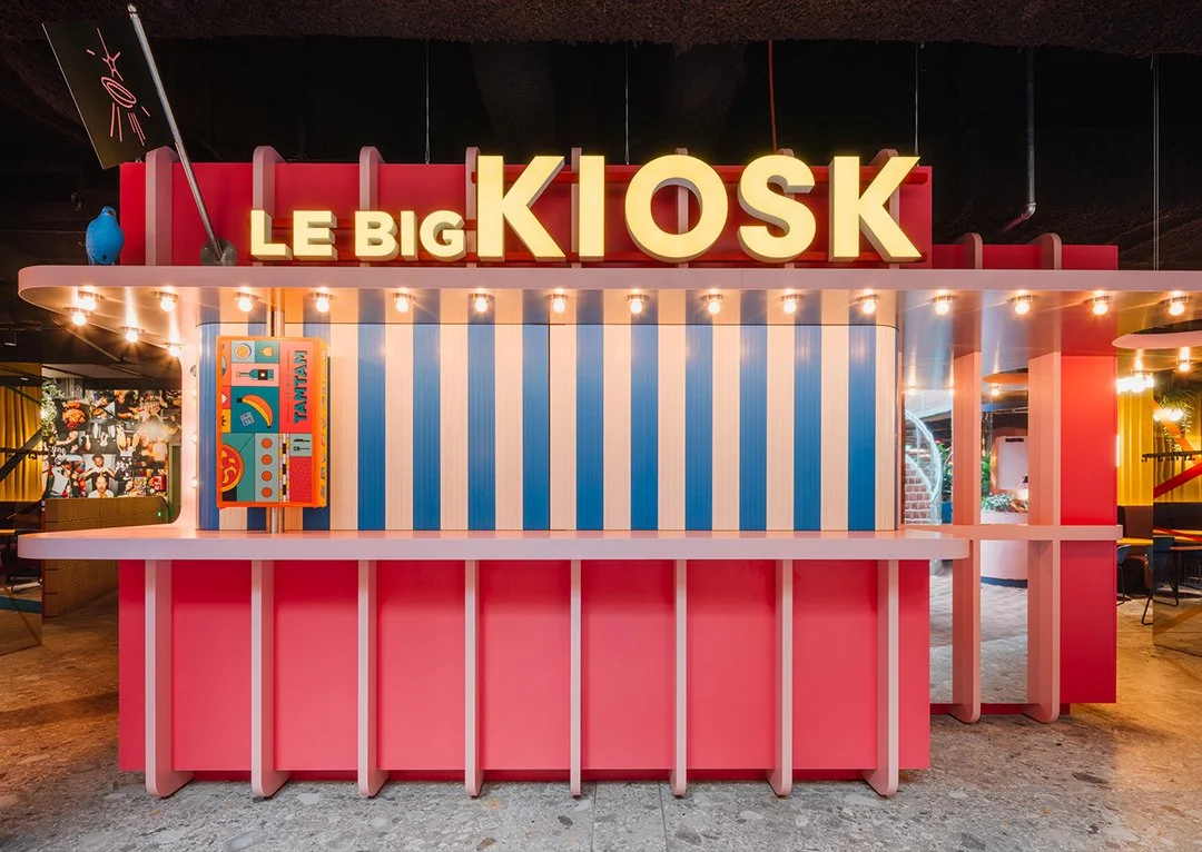 Colourful illuminated kiosk within the Le big TamTam food court in Hamburg