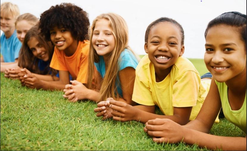 Happy Children Lying on Grass