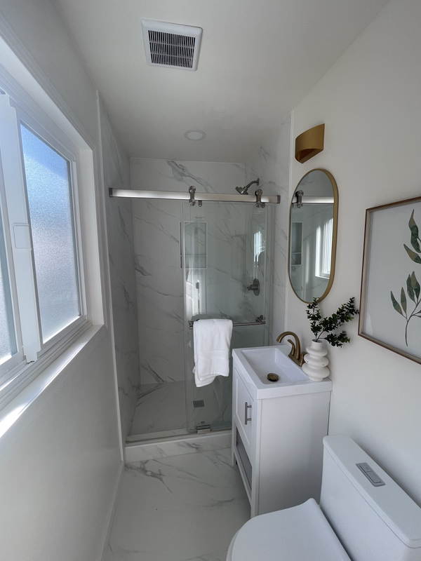 Modern walk-in shower with frameless glass and clean tile lines