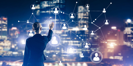 Businesswoman looking at a cityscape with social media connection icons.