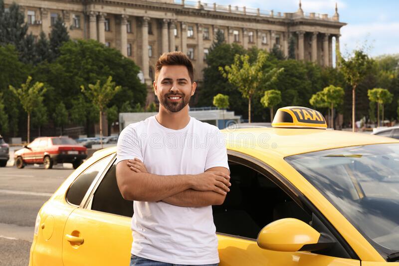 handsome-taxi-driver-near-car-city-street-231914357.jpg