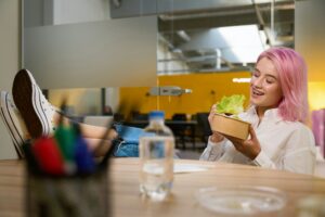 young-woman-having-lunch-in-the-office-300×200.jpg