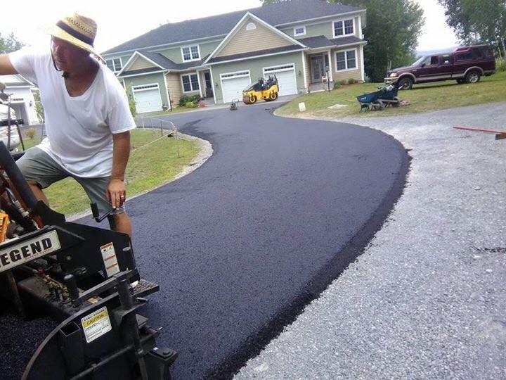 Paving crew laying fresh asphalt driveway residential Idaho