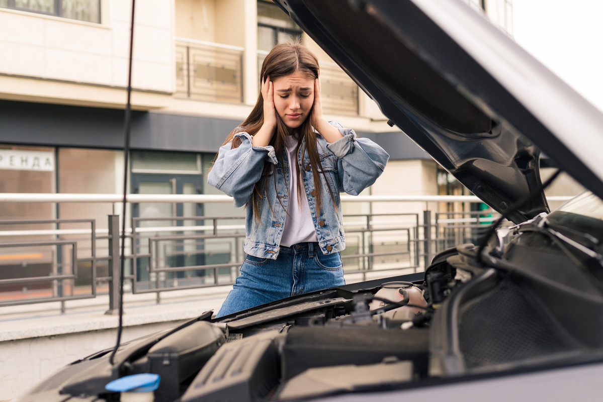 Common Myths About Buying Used Cars Young-worried-girl-is-using-phone-explain-mechanic-problem-with-car-that-she-has-Easy-Resize-com