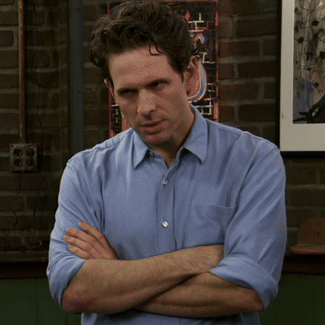 a gif of dennis reynolds from it's always sunny in philadelphia looking disheveled.