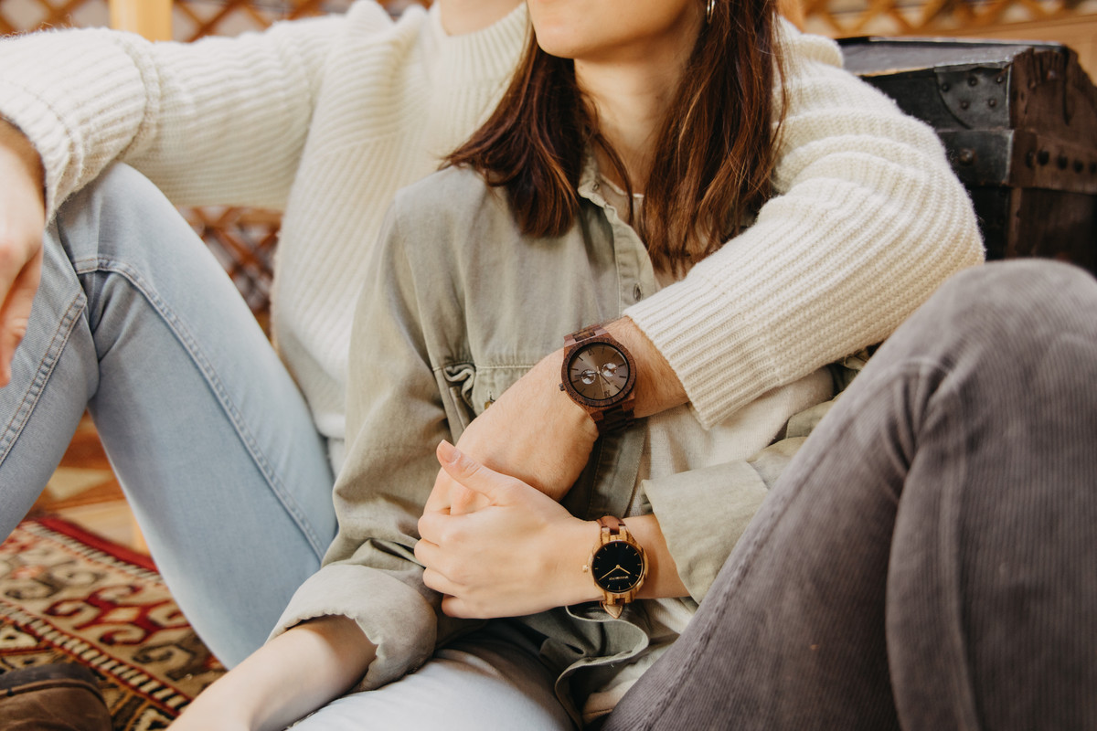 Close-up-of-engraved-wooden-watch-with-initials-and-meaningful-message