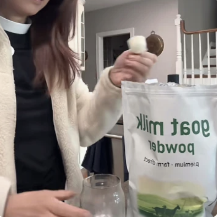 Customer holding goat milk powder bag