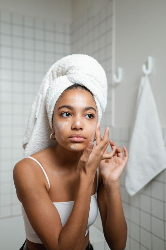 a woman washing her face with surfactant ingredients 