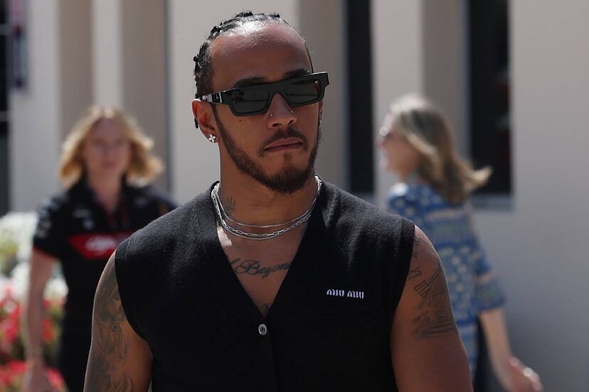 Lewis Hamilton walking to the the team pit box