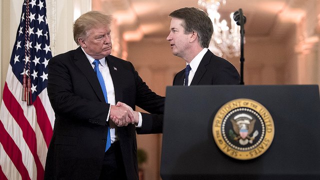 President Donald Trump shakes hands with Brett Kavanaugh.