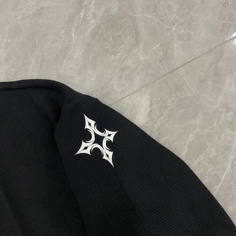 Kurevale sleeve print detail, four-pointed cross mark