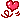 A pixel art gif of a heart floating around