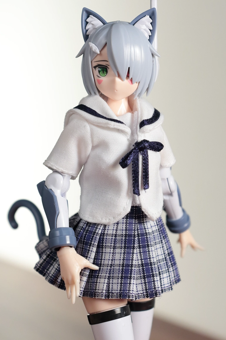 A front view of “Variable Fighter Girls” Kairos girl wearing a 1/12 White Collar Check Sailor Uniform Set in blue