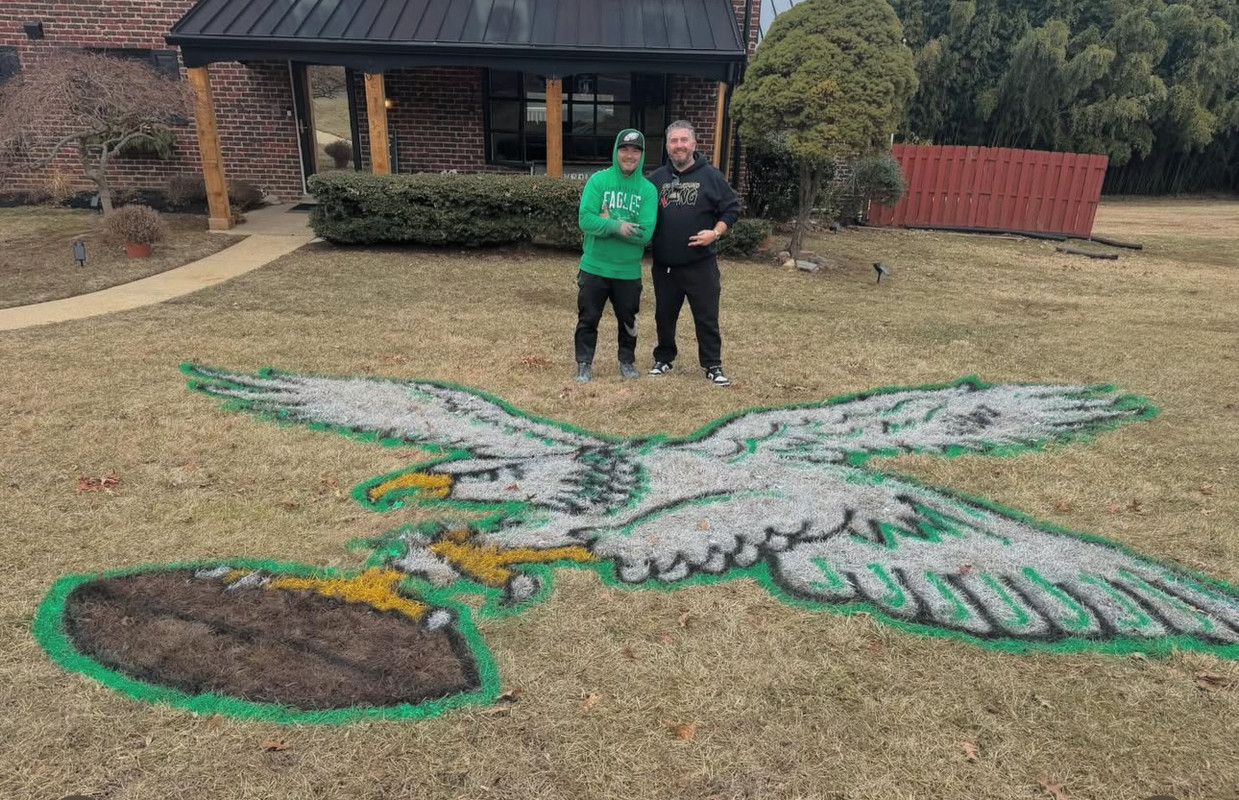 A detailed shot of a custom Phillies logo painted on a lawn.